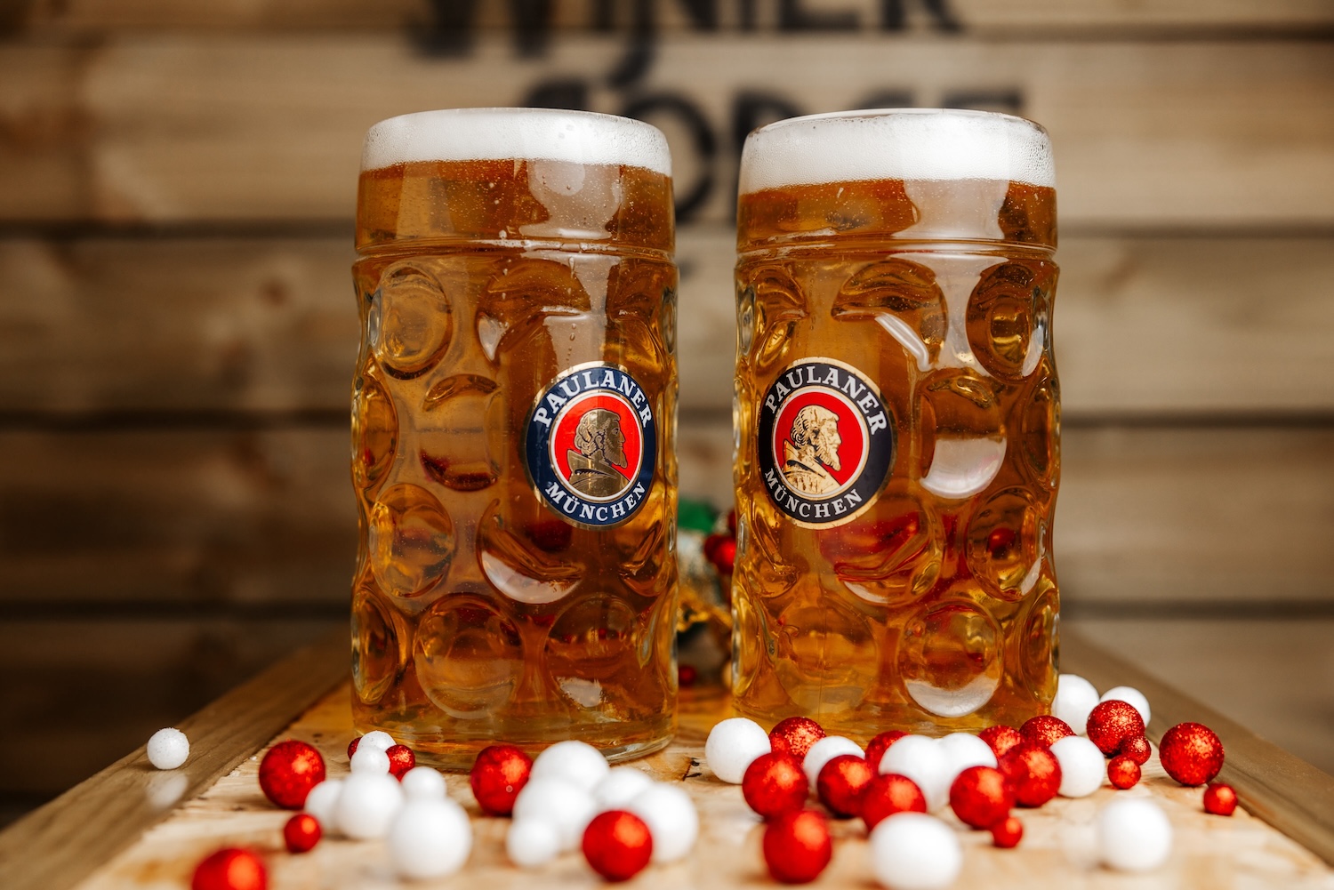 Two litre steins of Paulaner lager in front of The Winter Lodge sign